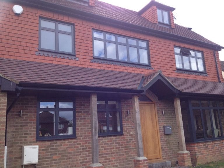 Redbrick House With Black Window Frames and Detailing