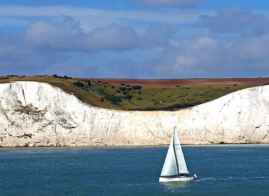 Sailboat Passing In Front of Dover Cliffs