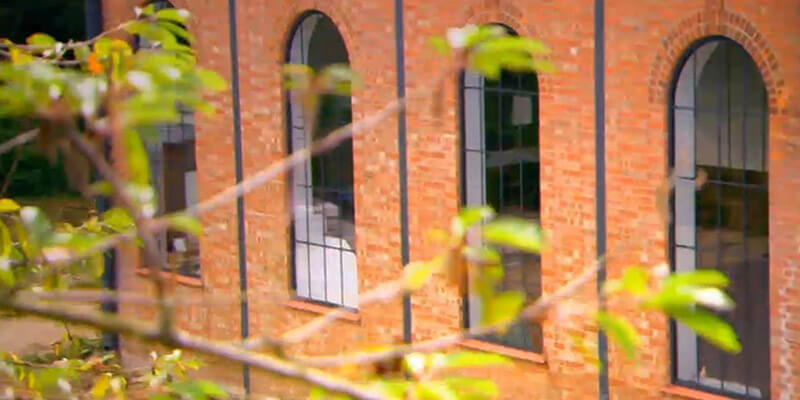 Exterior View of Black Arch Windows on Redbrick Building