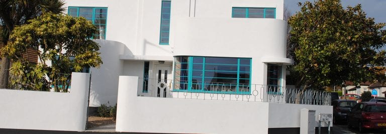 Exterior of White Home With Blue Window Frames
