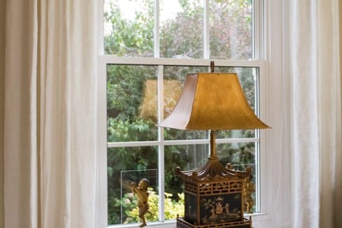 Interior View of a Window with a Lamp in Front