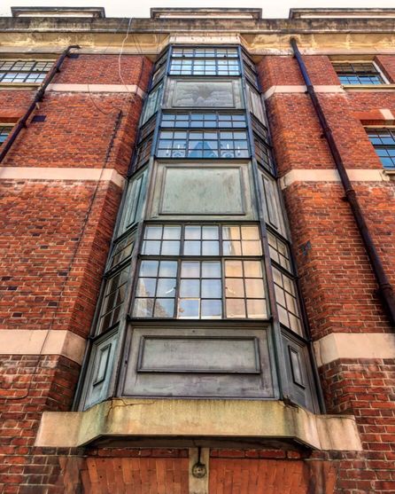 Exterior Vertical View of Redbrick Building with Bay Windows