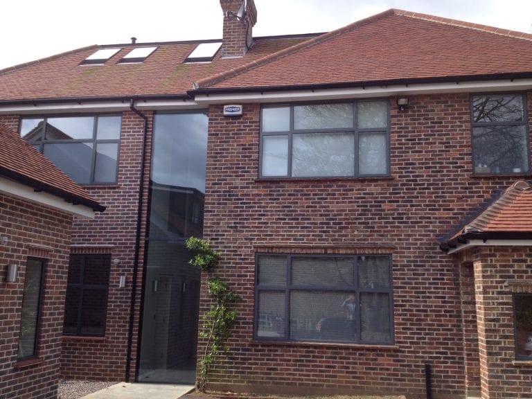 Redbrick House With Black Window Frames and Detailing