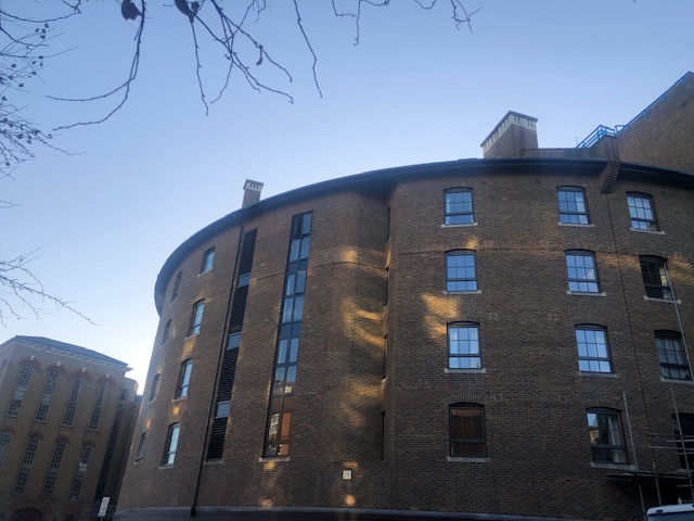 Exterior of Large Circular Building with Black Windows