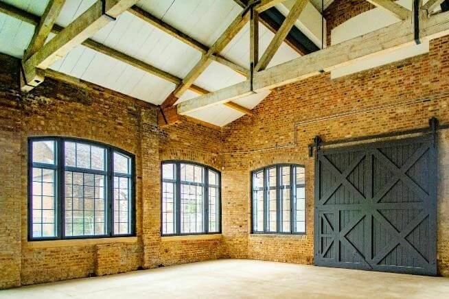 Converted Warehouse With Black Doors and Window Frames